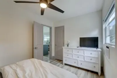 a bedroom with a bed and a ceiling fan at Bahama Mama Las Olas and Holiday Park w Hot Tub in Fort Lauderdale