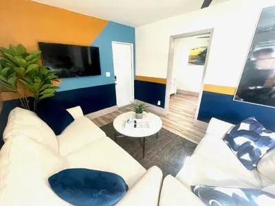 a living room with a white couch and a tv at Bahama Mama Las Olas and Holiday Park w Hot Tub in Fort Lauderdale