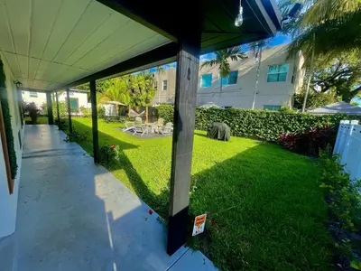 a patio with a grass yard with a building at Moody Stoody-O in Las Olas Beach and Holiday Park in Fort Lauderdale