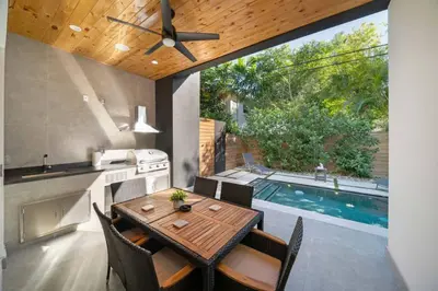 a kitchen and dining room with a table and a pool at Luxury Home w 2 Pools near Beach in Fort Lauderdale