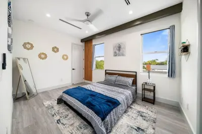 a bedroom with a large bed and a window at Luxury Home w 2 Pools near Beach in Fort Lauderdale