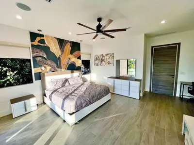 a bedroom with a bed and a ceiling fan at The Botanical Oasis Las Olas in Fort Lauderdale