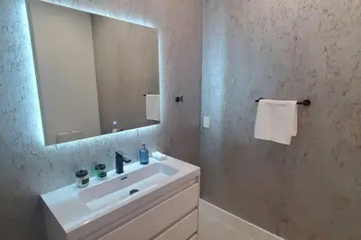 a bathroom with a sink and a mirror at The Botanical Oasis Las Olas in Fort Lauderdale