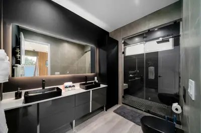 a bathroom with two sinks and a shower at Las Olas Zen Home with Pool and Hot Tub Near Beach in Fort Lauderdale