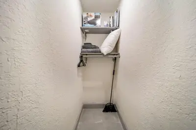 a small hallway with a white wall and a shelf at Newly Renovated Tropical Oasis Near Las Olas Beach in Fort Lauderdale