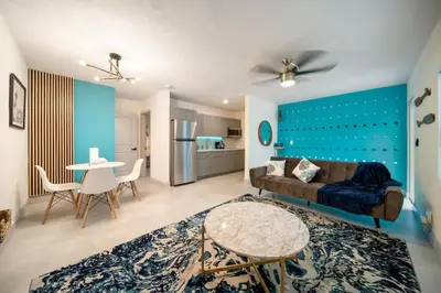 a living room with a couch and a table at Las Olas Newly Renovated Coastal 1BR Near Beach in Fort Lauderdale