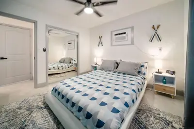 a bedroom with a large bed and a mirror at Las Olas Newly Renovated Coastal 1BR Near Beach in Fort Lauderdale