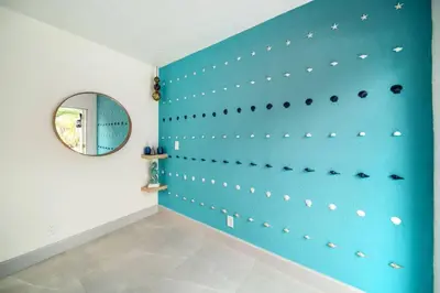 a room with a blue wall with a mirror at Las Olas Newly Renovated Coastal 1BR Near Beach in Fort Lauderdale
