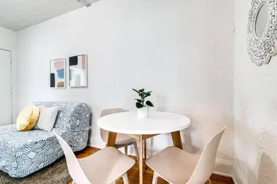 a white room with a table and chairs and a chair at Cozy Little Havana Apt Centrally located Hv2 in Miami
