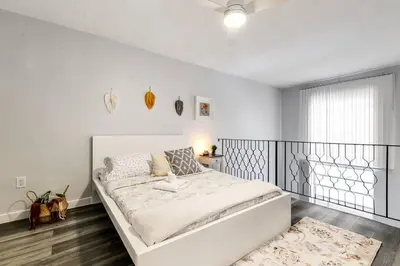 a white bedroom with a large bed and a window at Airport Loft 1b full kitchen Virg 10 in Miami