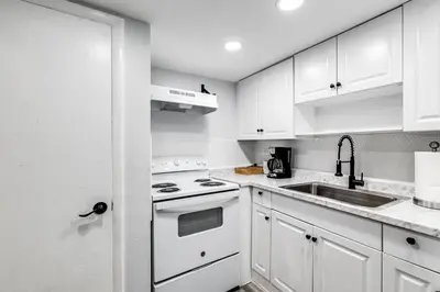 a white kitchen with a stove and a sink at Airport Loft 1b full kitchen Virg 10 in Miami