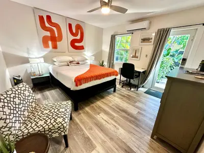 a bedroom with a bed and a desk and a chair at The Agustin Guesthouse - Men Only Clothing Optional in Fort Lauderdale