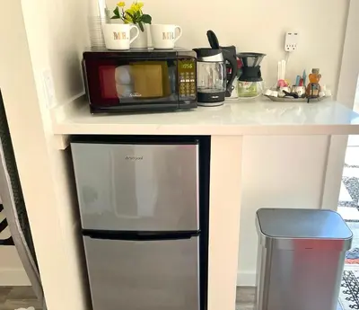 a kitchen counter with a microwave and a coffee maker at The Agustin Guesthouse - Men Only Clothing Optional in Fort Lauderdale