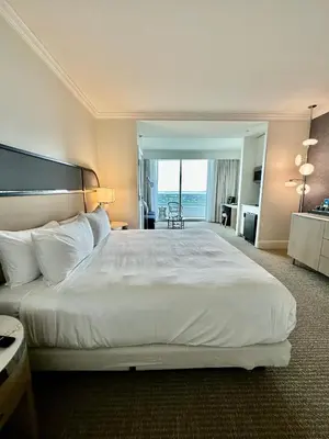 a bedroom with a large bed with a view of the ocean at Fontainebleau Miami Beach,Tresor in Miami Beach