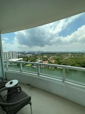 a balcony with two chairs and a view of the city at Fontainebleau Miami Beach,Tresor in Miami Beach
