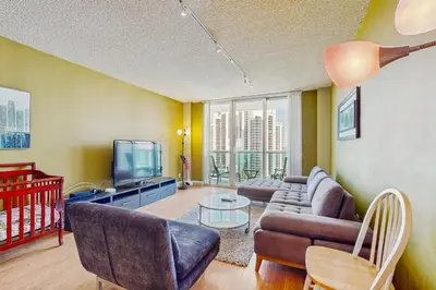 a living room with a couch and a tv at Ocean Reserve 1607 in Miami Beach