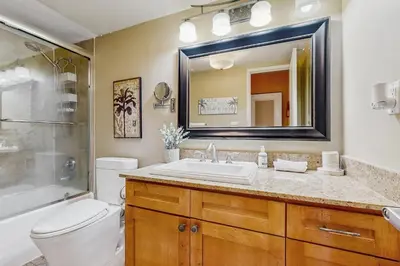a bathroom with a sink and a toilet and a mirror at Ocean Reserve 1607 in Miami Beach