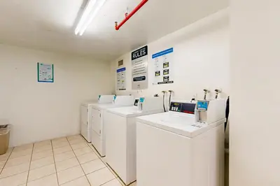 a row of washers and dryers in a room at Ocean Reserve 1607 in Miami Beach