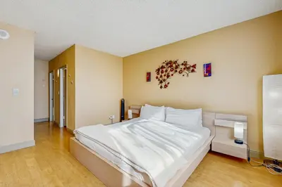 a bedroom with a large bed with white sheets at Ocean Reserve 1607 in Miami Beach