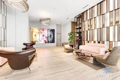 a living room with a pink couch and chairs at Luxury 1 Br Front Intracoastal View Balcony Pools in Hollywood
