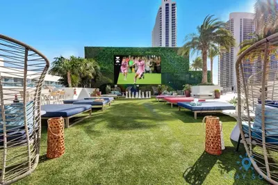 a large lawn with chairs and a large screen at Luxury 1 Br Front Intracoastal View Balcony Pools in Hollywood