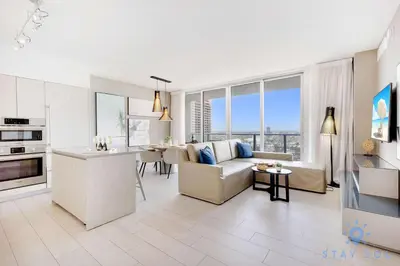 a kitchen and living room with a couch and a table at Luxury 1 Br Front Intracoastal View Balcony Pools in Hollywood