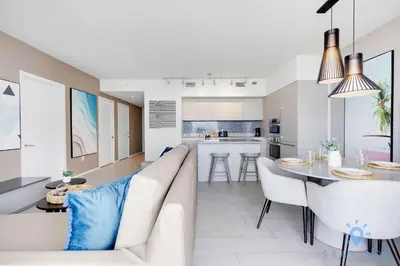 a living room and kitchen with a couch and a table at Luxury 1 Br Front Intracoastal View Balcony Pools in Hollywood
