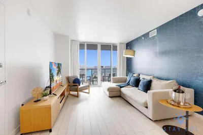 a living room with a couch and a table at Beachwalk Resort - Pool - Gym - Amazing view in Hallandale Beach