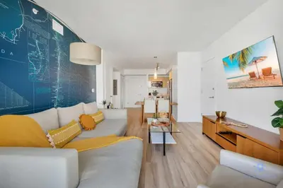 a living room with a couch and a table at Amazing Pool - Apartment with Balcony and Gym in Hallandale Beach