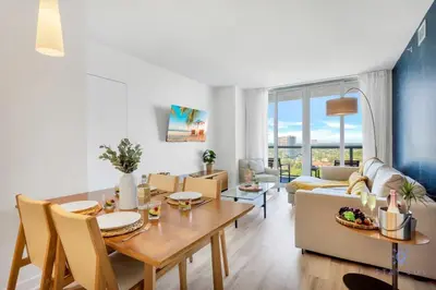 a living room with a table and a couch at Amazing Pool - Apartment with Balcony and Gym in Hallandale Beach