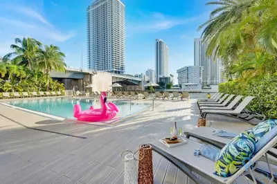 a pool with a pink flamingo in the middle of a city at Infinite Views Amazing Pool Gym in Hallandale Beach