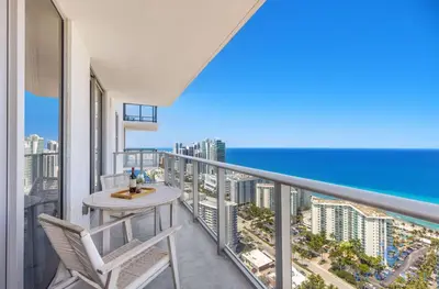 a balcony with a table and chairs and the ocean at Oceanfront Balcony Enjoy Endless Views Hot Tub in Hollywood
