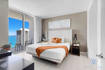 a bedroom with a bed with a view of the ocean at Oceanfront Balcony Enjoy Endless Views Hot Tub in Hollywood