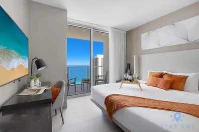 a bedroom with a bed and a view of the ocean at Oceanfront Balcony Enjoy Endless Views Hot Tub in Hollywood