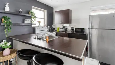 a kitchen with a stainless steel refrigerator and a counter at Brickell Pearl Cozy House Beach 10 min Location in Miami