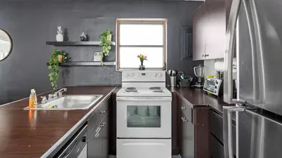a kitchen with a white stove and a sink at Brickell Pearl Cozy House Beach 10 min Location in Miami