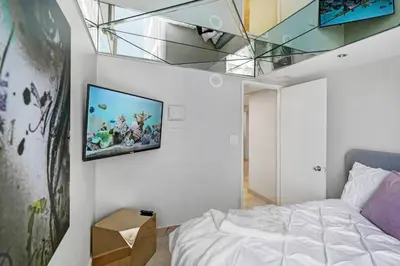 a bedroom with a bed and a tv on the wall at Wildest Dreams Penthouse! Dreams Do Come True in Miami