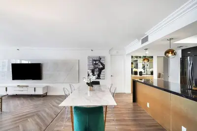 a kitchen and living room with a table and a tv at Magic City! Water And Park Views! in Miami