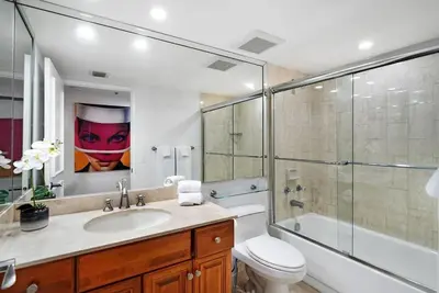 a bathroom with a toilet and a sink and a shower at Magic City! Water And Park Views! in Miami