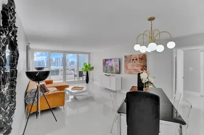 a living room with a couch and a table at Paradise Found! Miami Skyline and Water Views! in Miami
