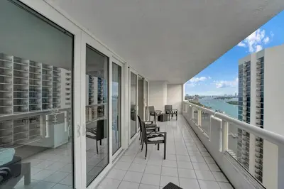 a balcony with chairs and a view of the water at Paradise Found! Miami Skyline and Water Views! in Miami