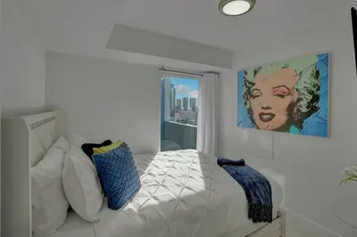 a bedroom with a bed with a painting on the wall at Elevate! Water and Park Views in Miami
