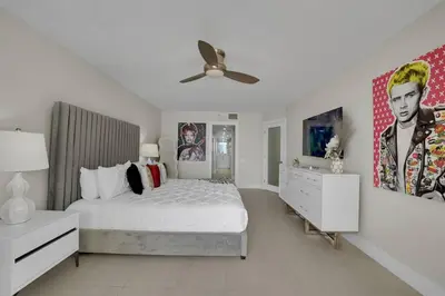 a white bedroom with a bed and a ceiling fan at Iconic! Miami Skyline & Water Views in Miami
