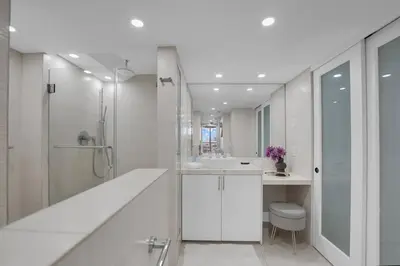 a white bathroom with a shower and a toilet at Iconic! Miami Skyline & Water Views in Miami