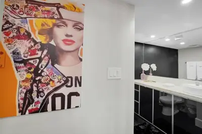 a bathroom with a large painting of a woman at Iconic! Miami Skyline & Water Views in Miami