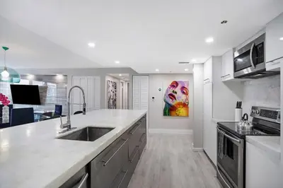 a kitchen with a sink and a counter top at Unforgettable! Water & Park Views, 4 Bedrooms! in Miami