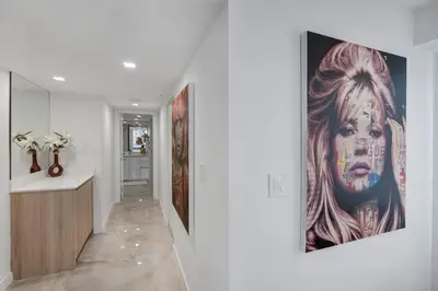 a hallway with a large painting on a wall at City of Dreams! Renovated With Water & Park Views in Miami
