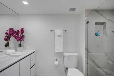 a bathroom with a toilet and a sink and a shower at City of Dreams! Renovated With Water & Park Views in Miami