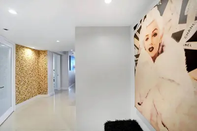 a hallway of a house with a large painting on the wall at Some Like It Hot! Miami Skyline & Water Views 4BR in Miami
