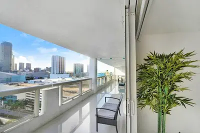 a balcony with two chairs and a view of the city at Some Like It Hot! Miami Skyline & Water Views 4BR in Miami